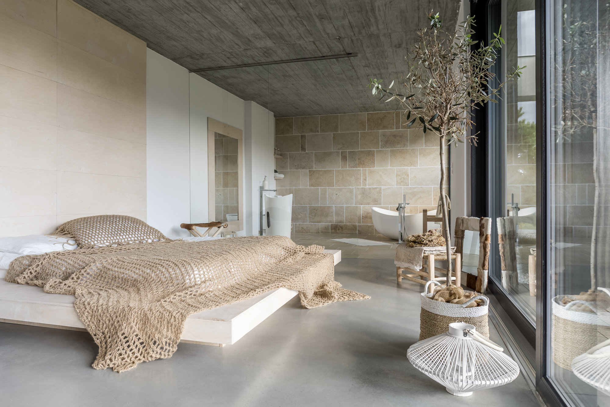 Dormitorio abierto al baño minimalista con mampara invisible