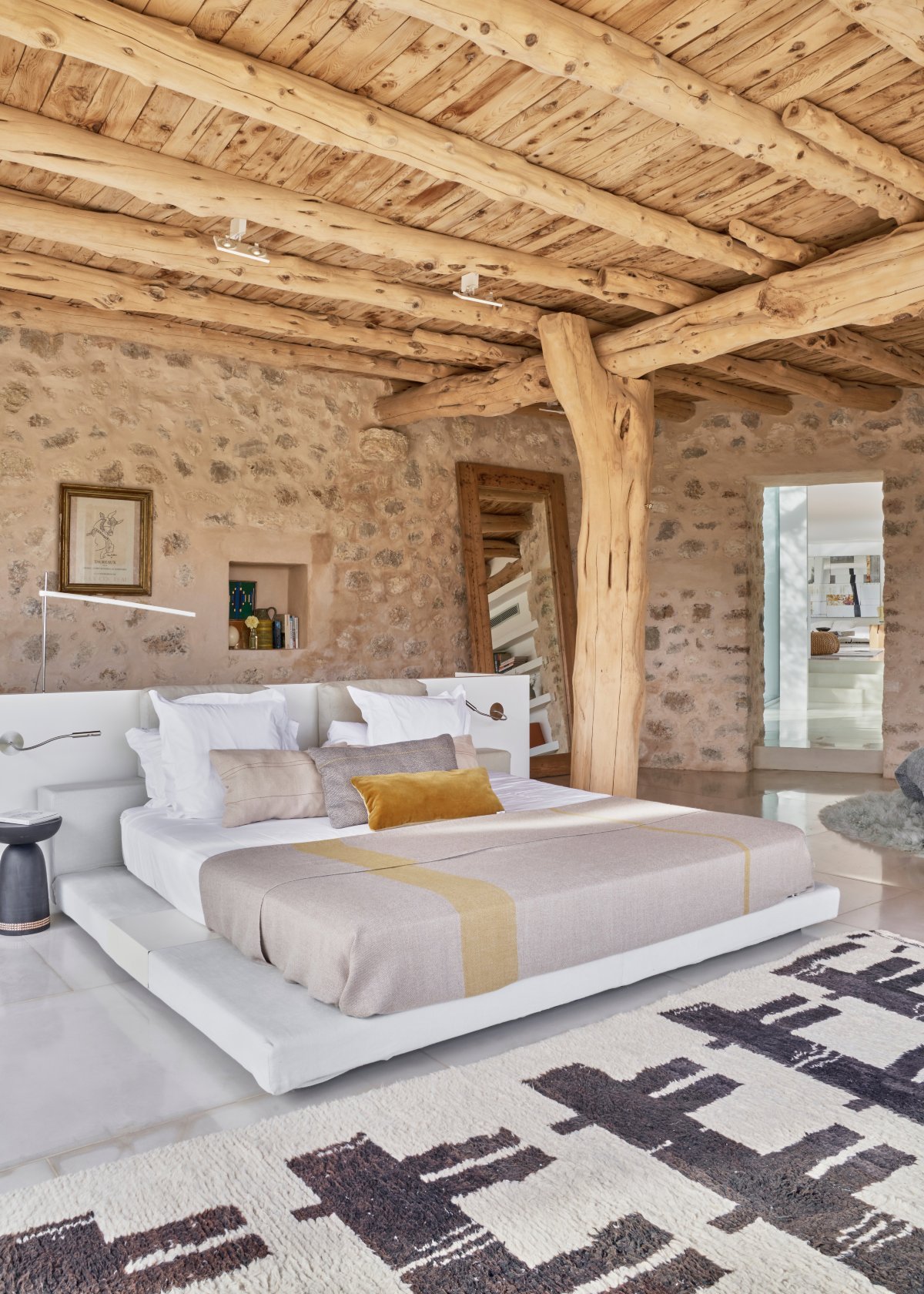 Dormitorio rústico con techo de troncos de madera