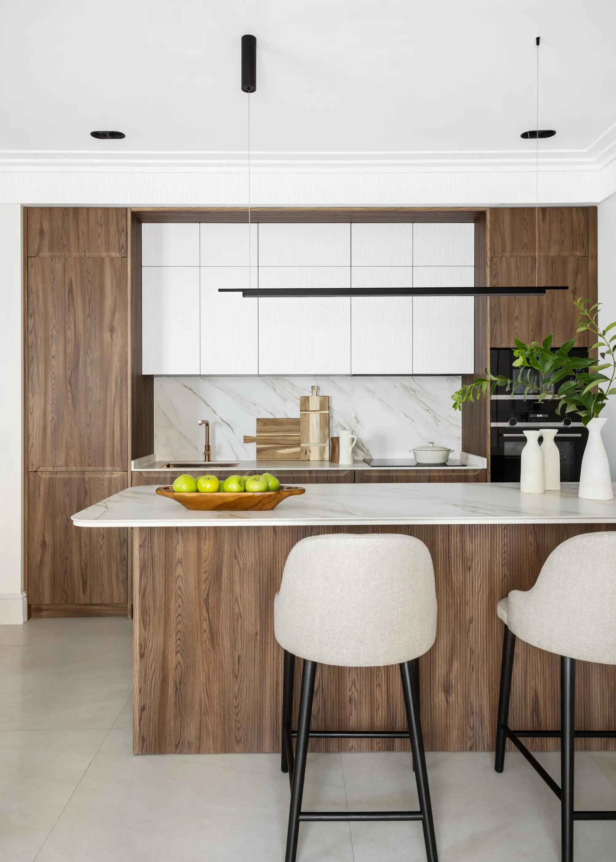 cocina abierta en blanco y madera con barra y taburetes