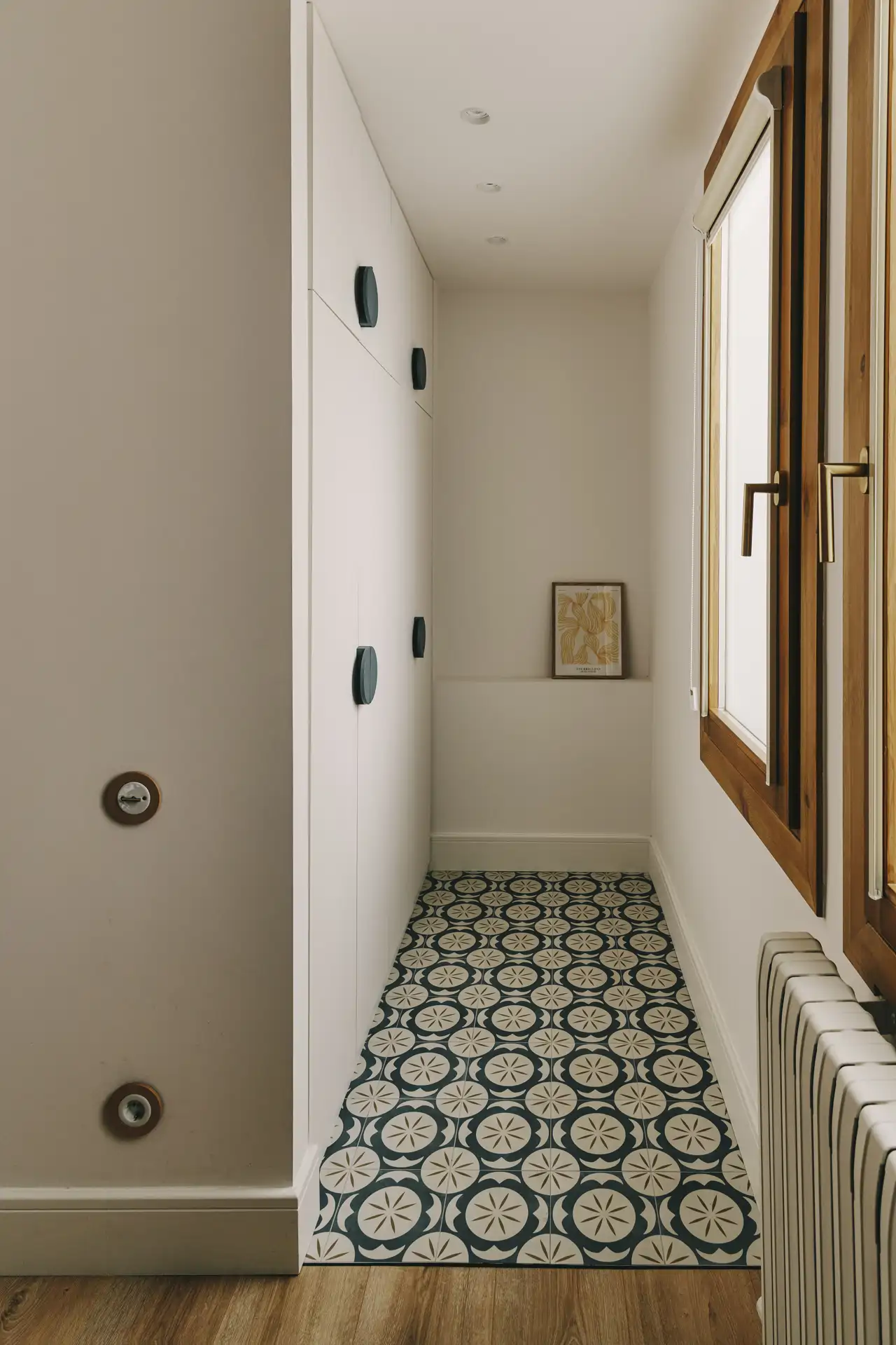 Armarios blancos, cerámica y ventanas de madera