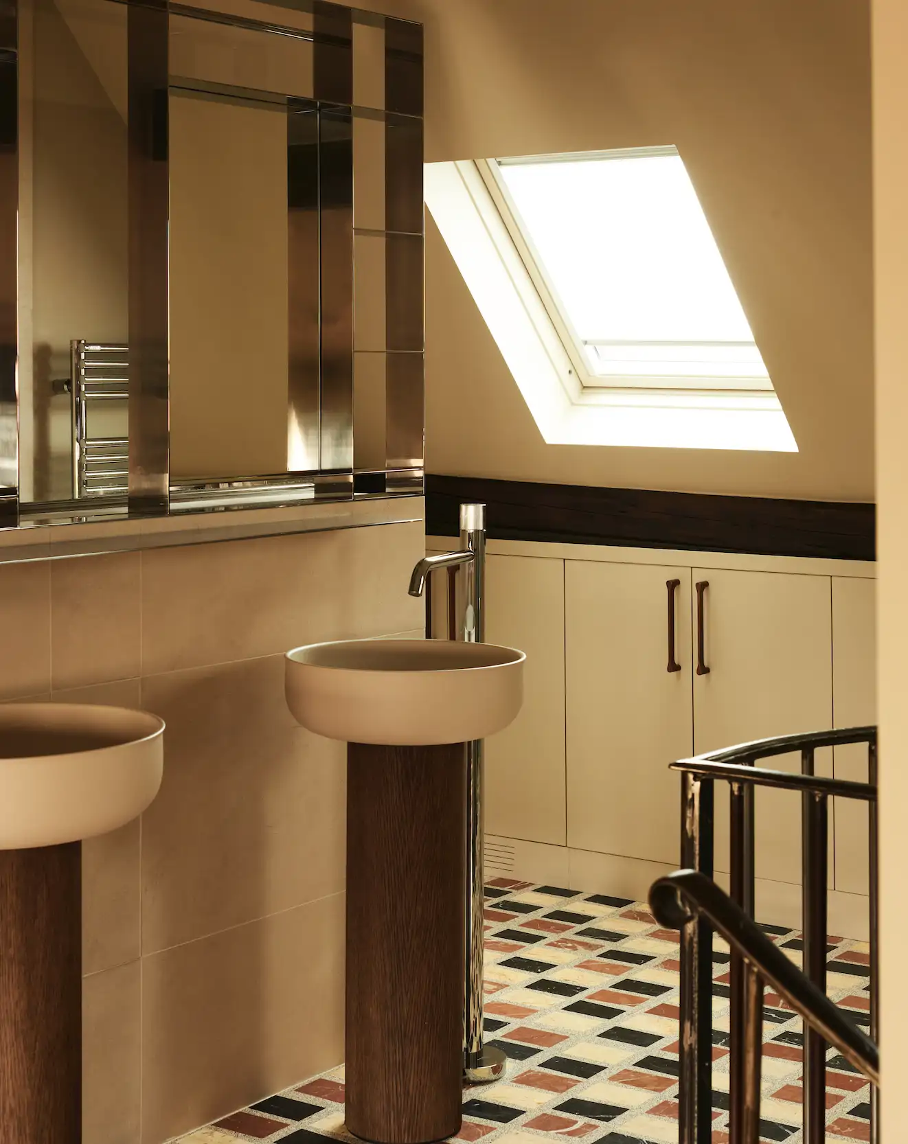 BAÑO. Suelo de terrazo, diseñado a media, igual que el espejo de níquel pulido.