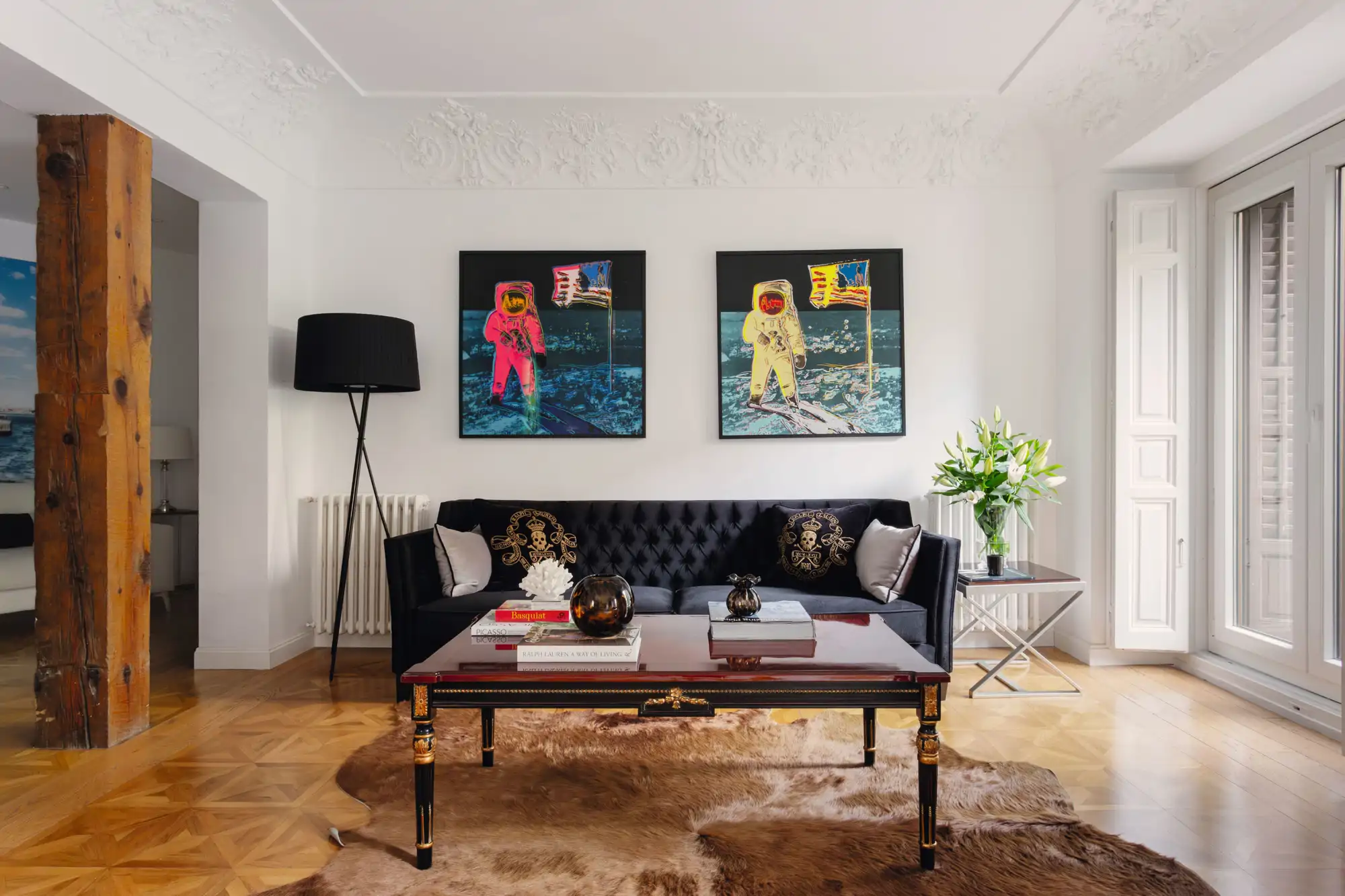 Salón con sofá chester oscuro y cuadros